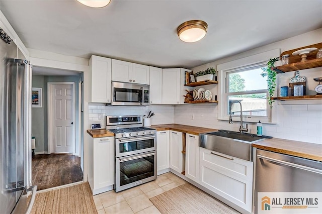 121 E Cliff Rd, Colonia, NJ 07067 - kitchen with stainless steel appliances, butcher block counters, and open shelves
