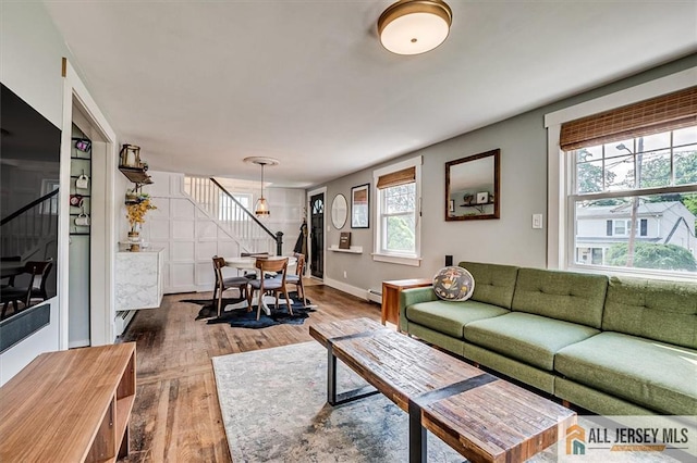 121 E Cliff Rd, Colonia, NJ 07067 - living room featuring stairway, wood finished floors, and baseboard heating