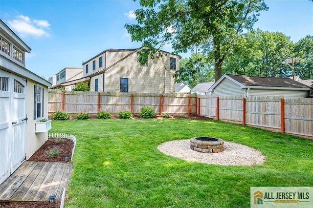 121 E Cliff Rd, Colonia, NJ 07067 - fenced backyard with an outdoor fire pit