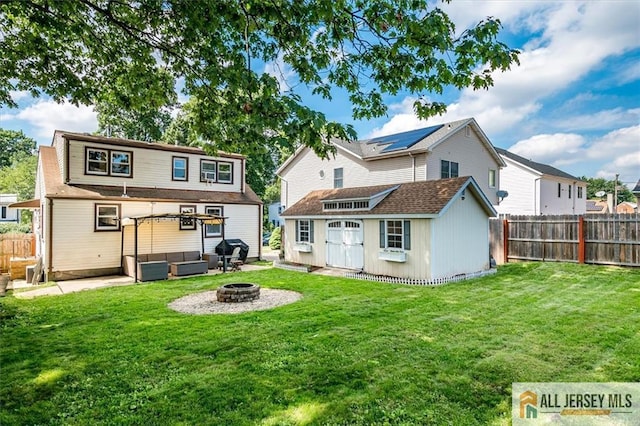 121 E Cliff Rd, Colonia, NJ 07067 - back of house with an outbuilding, an outdoor living space with a fire pit, a fenced backyard, and a patio
