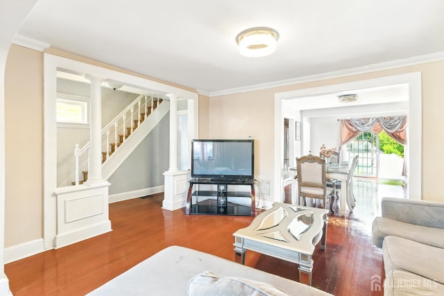 68 Pennsylvania Ave, Perth Amboy, NJ 08861 - living area with wood finished floors, ornate columns, stairway, crown molding, and baseboards