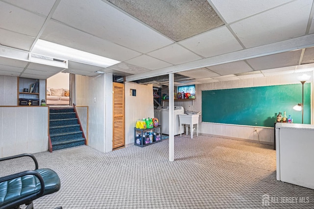 1208 Omaha Rd, North Brunswick, NJ 08902 - finished below grade area featuring a paneled ceiling, carpet, wooden walls, and stairway