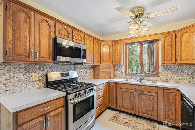 1208 Omaha Rd, North Brunswick, NJ 08902 - kitchen featuring appliances with stainless steel finishes, brown cabinetry, a ceiling fan, and light countertops