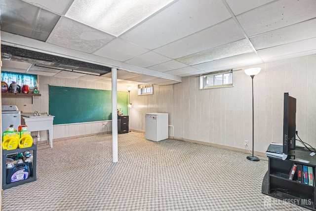 1208 Omaha Rd, North Brunswick, NJ 08902 - basement with fridge, carpet flooring, a paneled ceiling, and wood walls
