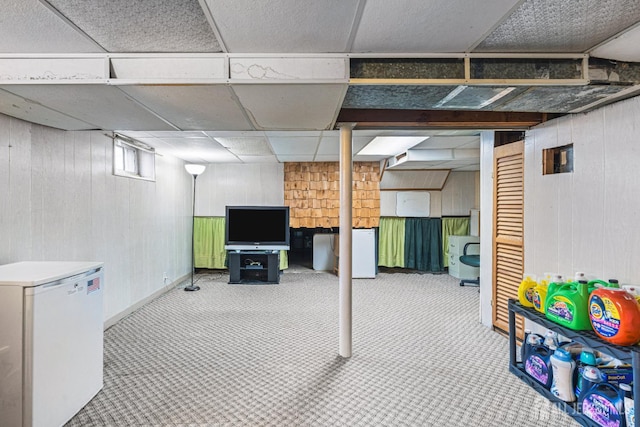 1208 Omaha Rd, North Brunswick, NJ 08902 - below grade area featuring refrigerator, wood walls, carpet, and a paneled ceiling
