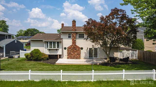 1208 Omaha Rd, North Brunswick, NJ 08902 - rear view of property with a chimney, a fenced backyard, and a patio