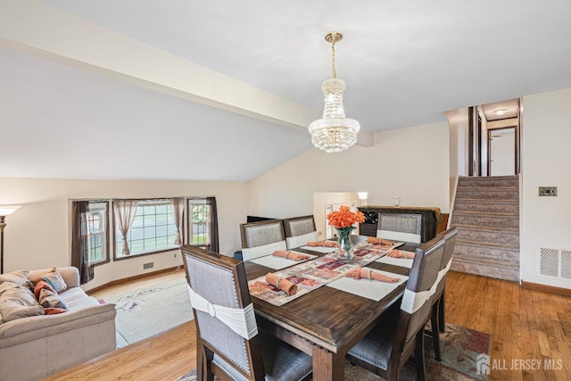 1208 Omaha Rd, North Brunswick, NJ 08902 - dining space featuring a chandelier, light wood-style floors, and stairs