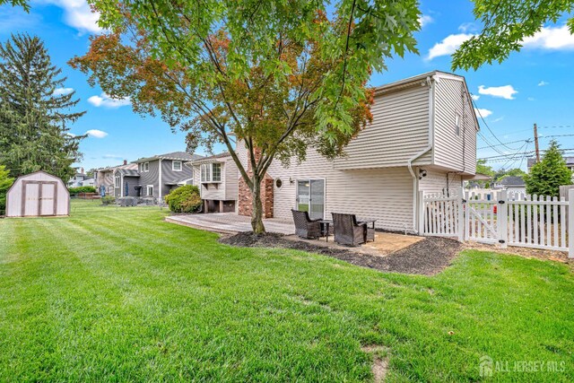 1208 Omaha Rd, North Brunswick, NJ 08902 - back of property featuring a gate, a storage shed, a patio, and a residential view