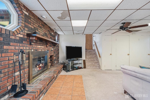 1208 Omaha Rd, North Brunswick, NJ 08902 - living room featuring a fireplace, carpet flooring, a drop ceiling, and stairs