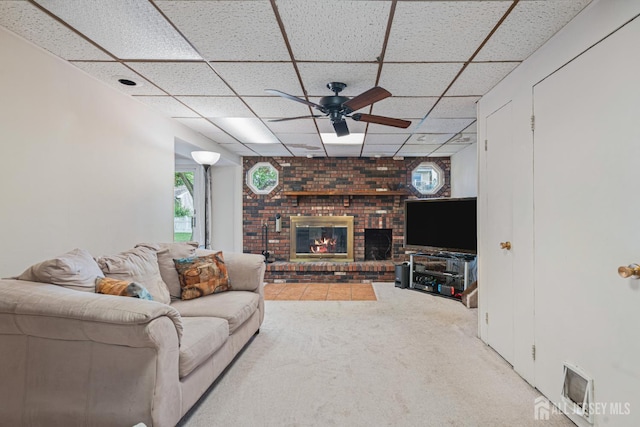 1208 Omaha Rd, North Brunswick, NJ 08902 - living area featuring a drop ceiling, ceiling fan, a brick fireplace, and carpet flooring