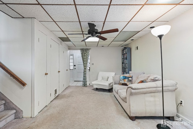 1208 Omaha Rd, North Brunswick, NJ 08902 - living area with light carpet, a paneled ceiling, a ceiling fan, and stairs