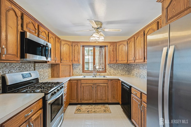 1208 Omaha Rd, North Brunswick, NJ 08902 - kitchen featuring appliances with stainless steel finishes, ceiling fan, brown cabinetry, and light countertops