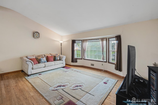 1208 Omaha Rd, North Brunswick, NJ 08902 - living area featuring wood finished floors and vaulted ceiling