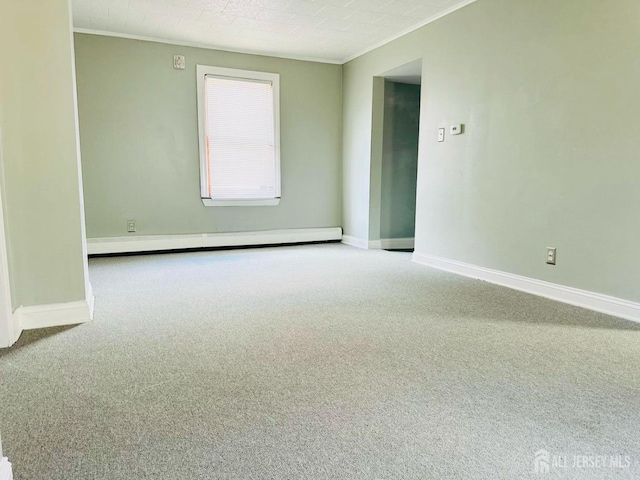 spare room featuring crown molding, a baseboard radiator, carpet, and baseboards