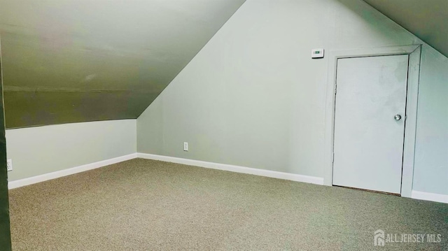 additional living space with carpet floors, baseboards, and lofted ceiling