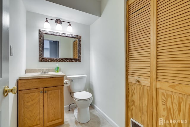 bathroom featuring vanity, toilet, and tile patterned flooring