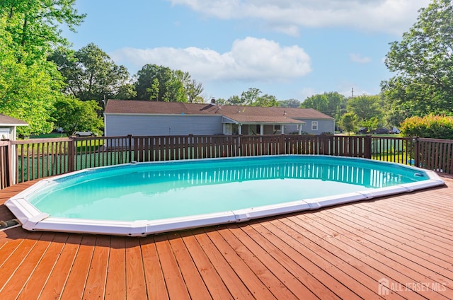 1682 Taylor Dr, North Brunswick, NJ 08902 - view of swimming pool featuring a wooden deck and view of wooded area