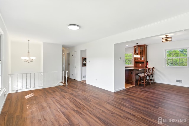 1682 Taylor Dr, North Brunswick, NJ 08902 - living room with dark wood-style floors and a chandelier