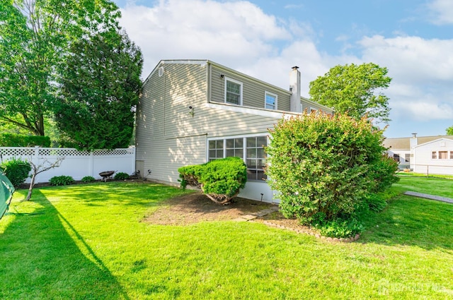 1682 Taylor Dr, North Brunswick, NJ 08902 - back of house featuring a chimney
