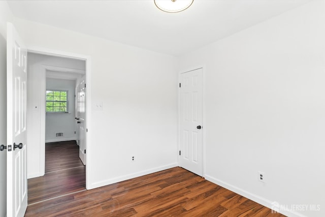 1682 Taylor Dr, North Brunswick, NJ 08902 - empty room featuring dark wood-style floors and baseboards
