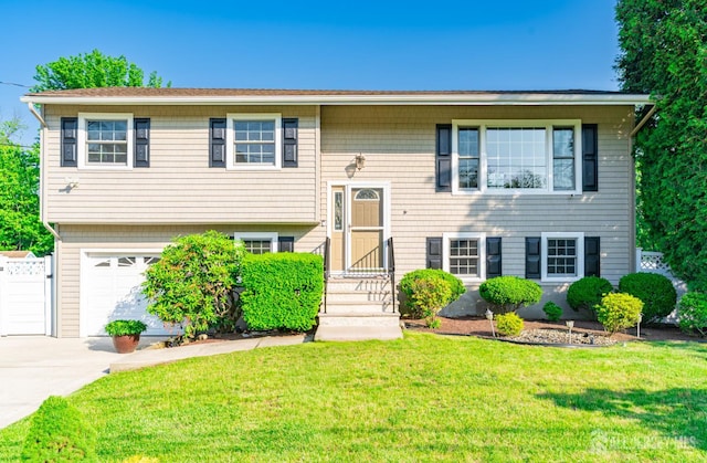 1682 Taylor Dr, North Brunswick, NJ 08902 - split foyer home featuring a front yard, driveway, and an attached garage