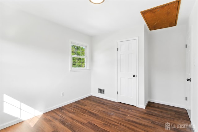 1682 Taylor Dr, North Brunswick, NJ 08902 - unfurnished bedroom with dark wood-style flooring, attic access, and a closet