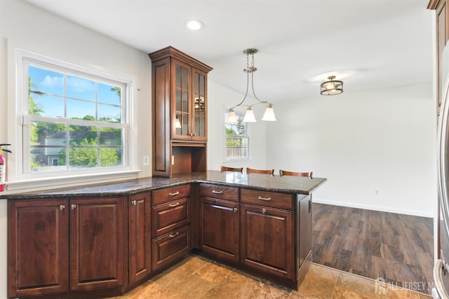 1682 Taylor Dr, North Brunswick, NJ 08902 - kitchen with glass insert cabinets, hanging light fixtures, dark stone countertops, recessed lighting, and dark brown cabinetry