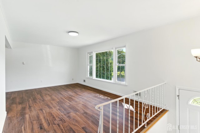 1682 Taylor Dr, North Brunswick, NJ 08902 - empty room with dark wood-type flooring and baseboards