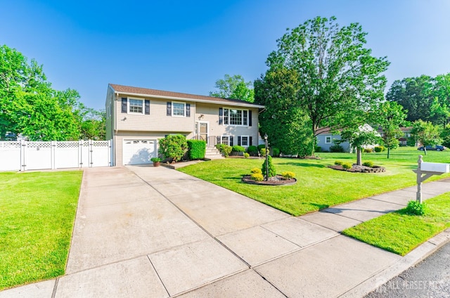 1682 Taylor Dr, North Brunswick, NJ 08902 - bi-level home featuring driveway, an attached garage, and a gate