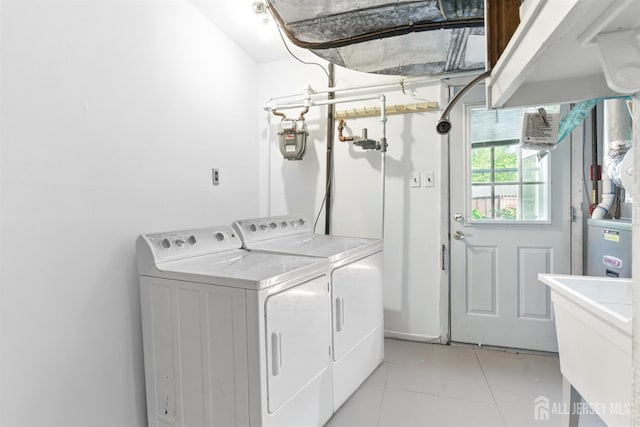 1682 Taylor Dr, North Brunswick, NJ 08902 - laundry room with washing machine and clothes dryer and light tile patterned floors
