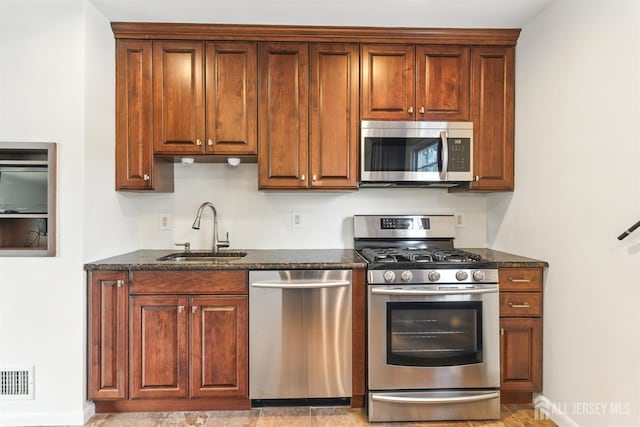 1682 Taylor Dr, North Brunswick, NJ 08902 - kitchen with appliances with stainless steel finishes and dark stone countertops