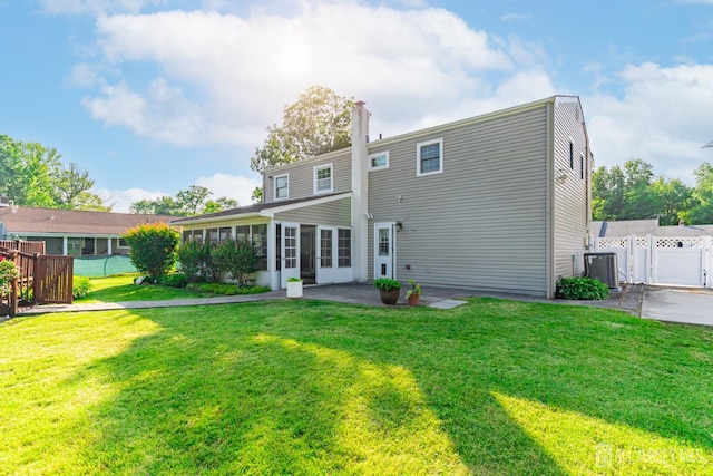 1682 Taylor Dr, North Brunswick, NJ 08902 - rear view of house featuring a gate, a patio area, a sunroom, and french doors