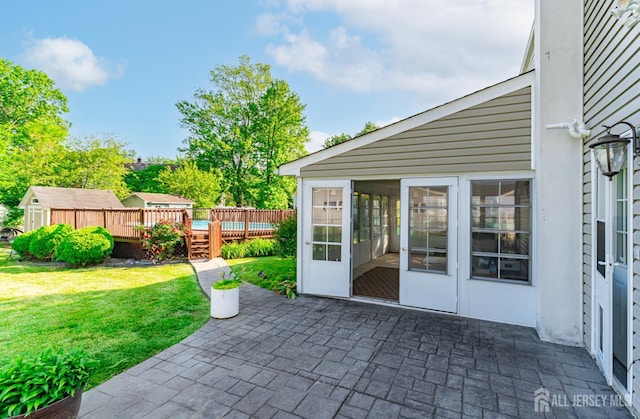 1682 Taylor Dr, North Brunswick, NJ 08902 - view of patio with a deck, an outbuilding, and a sunroom