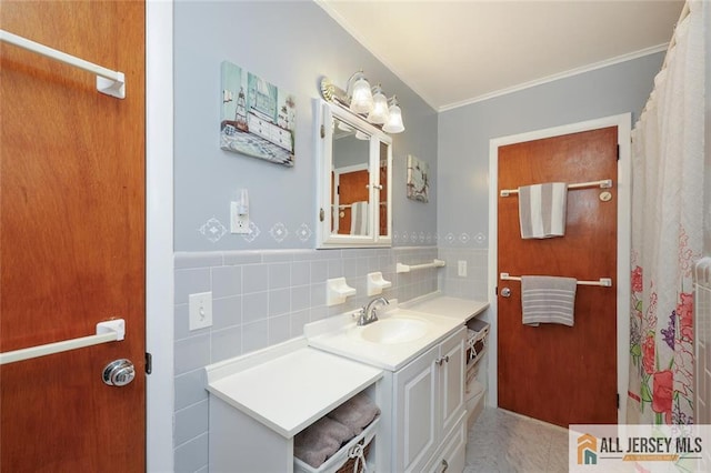 full bathroom featuring ornamental molding, vanity, and tile walls