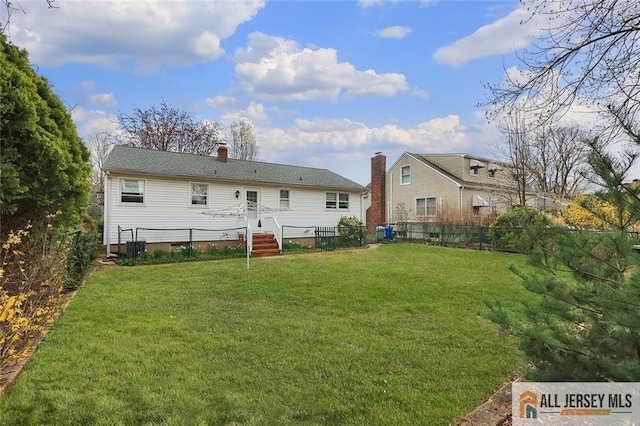 rear view of house featuring a chimney and crawl space