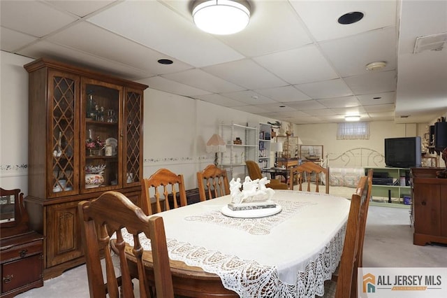 dining area with a paneled ceiling