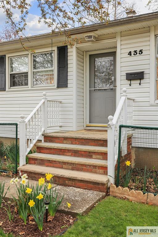 view of exterior entry featuring fence