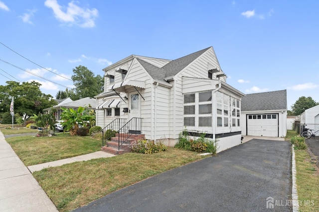 view of front of property with a front yard and a garage