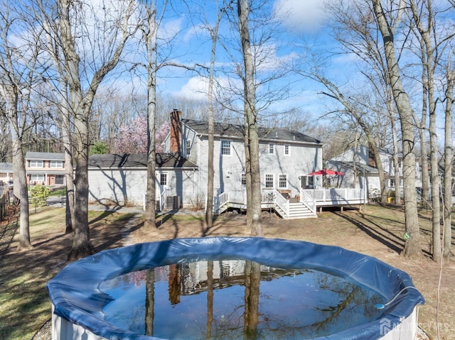 view of swimming pool featuring a wooden deck and a covered pool