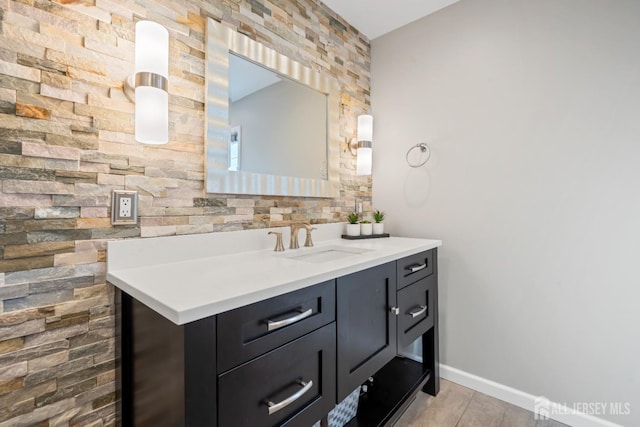 bathroom featuring baseboards and vanity
