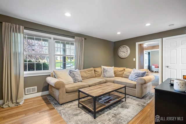 living area featuring recessed lighting, baseboards, visible vents, and light wood-style floors