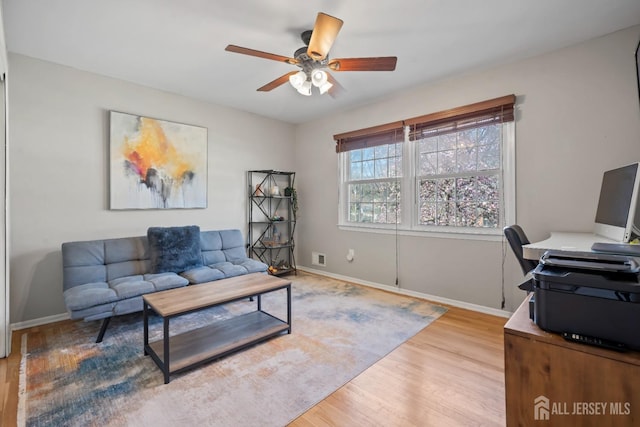 office with baseboards, ceiling fan, and wood finished floors