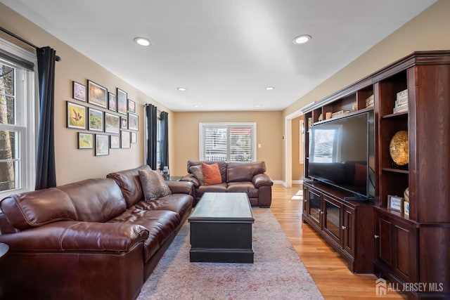 living room with recessed lighting and light wood-style flooring