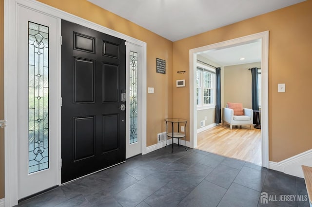 foyer entrance with baseboards