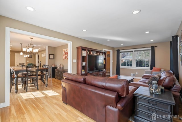 living room featuring recessed lighting, light wood finished floors, and visible vents