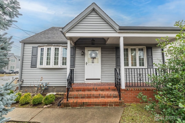 bungalow-style house with roof with shingles