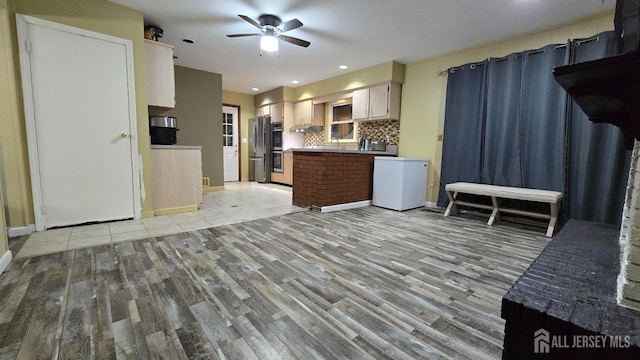 22 Delaney Ct, South Plainfield, NJ 07080 - kitchen featuring freestanding refrigerator, light wood-style floors, a ceiling fan, refrigerator, and tasteful backsplash