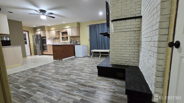 22 Delaney Ct, South Plainfield, NJ 07080 - kitchen with appliances with stainless steel finishes, a ceiling fan, backsplash, open floor plan, and light wood-style floors