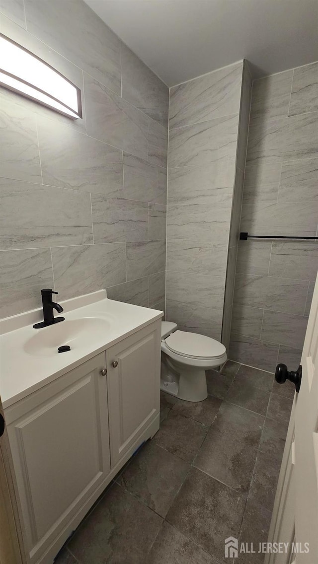 22 Delaney Ct, South Plainfield, NJ 07080 - half bathroom featuring tile walls, vanity, and toilet