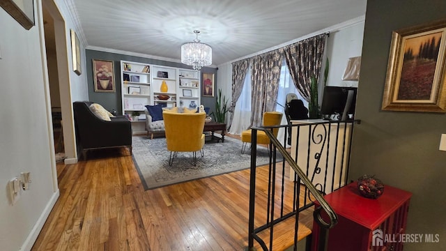22 Delaney Ct, South Plainfield, NJ 07080 - dining room with wood-type flooring, crown molding, a chandelier, baseboards, and built in shelves